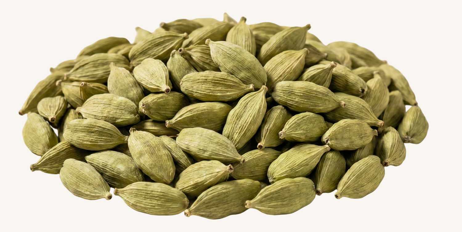 Pile of green cardamom pods on an ivory background