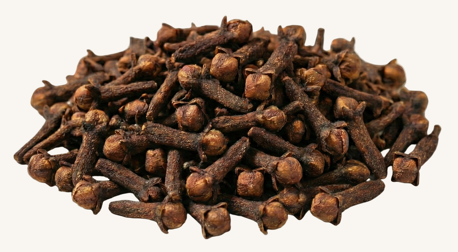 Pile of dried cloves on an ivory background